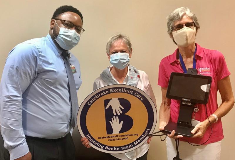 Kathee Brown celebrates the excellent care she received at Beebe Healthcare by donating a contactless temperature screening device. Shown are (l-r) Maurice Winkfield, Beebe Healthcare director of patient access; Brown; and Diane Barlow, Beebe Medical Foundation gift planning officer. SUBMITTED PHOTO